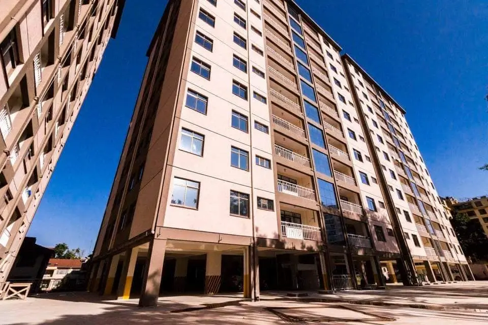 Multi-story residential building facade with ground-floor parking