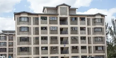 Multi-story residential apartment building with cream facade