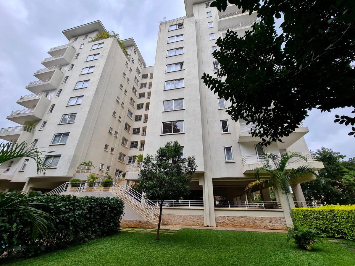 Modern apartment building facade with manicured grounds and landscaping