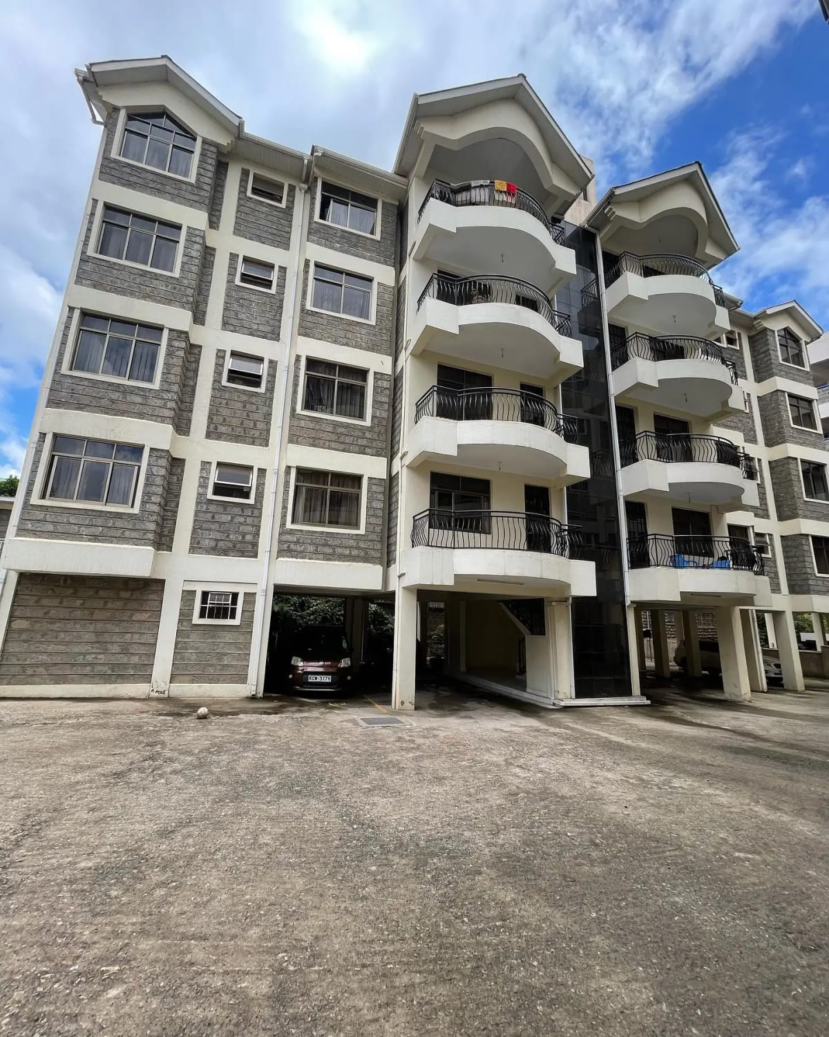 Modern multi-story residential building with curved balconies