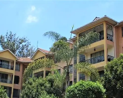 Multi-story residential building with yellow facade and balconies