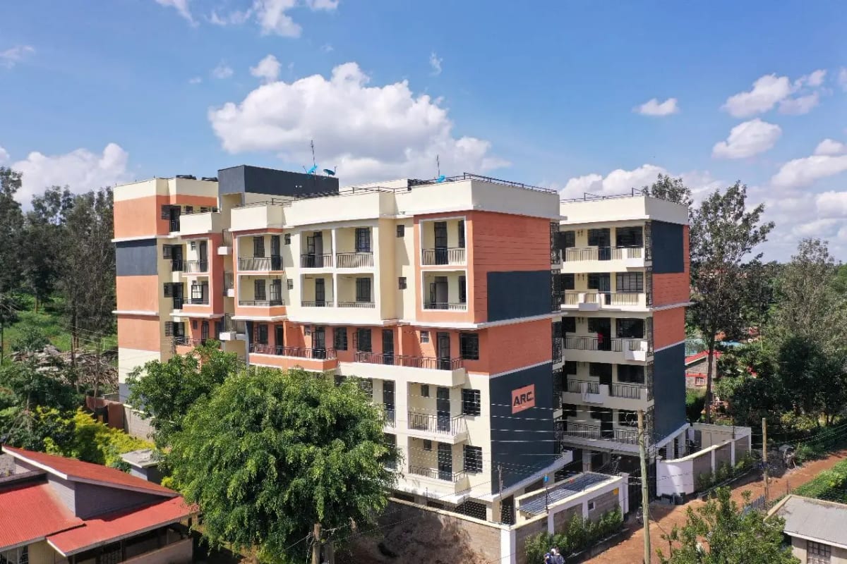 Modern multi-story residential building with mixed brick and cream facade