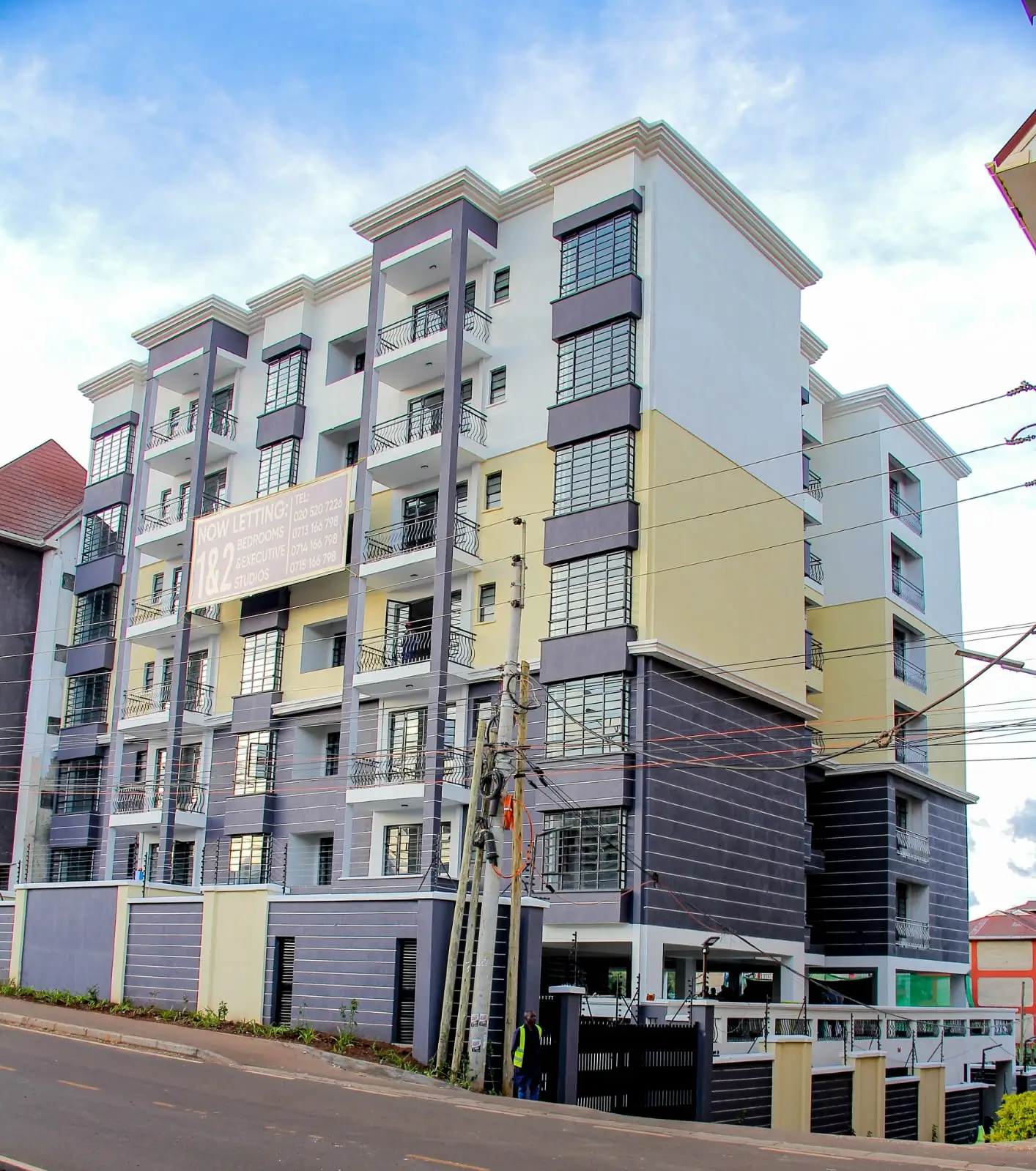 Modern multi-story residential building with mixed facade colors