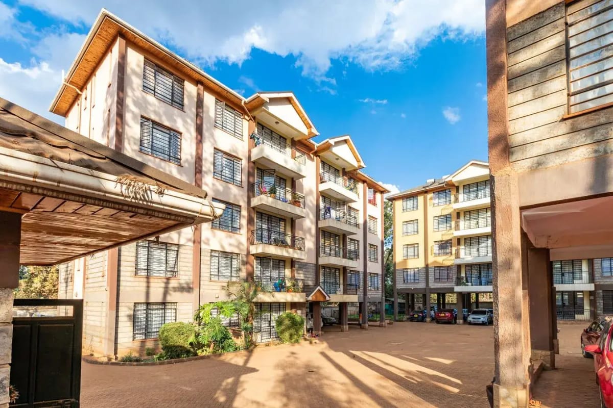 Multi-story residential apartment complex with courtyard entrance