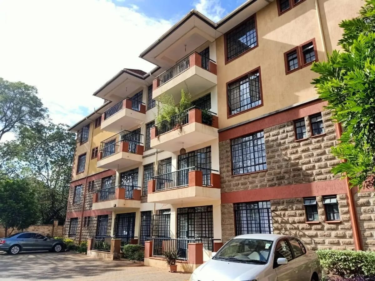 Multi-story residential building with cream and red facade