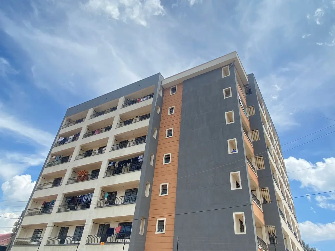 Modern multi-story residential building with balconies and mixed cladding