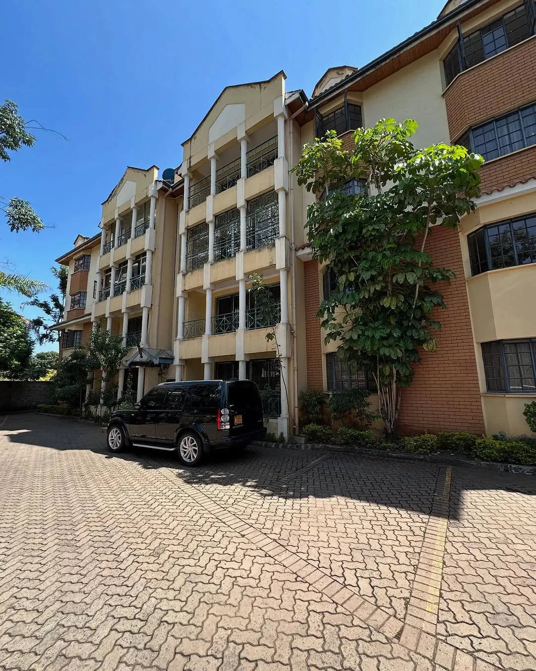Multi-story residential building facade with parking bay