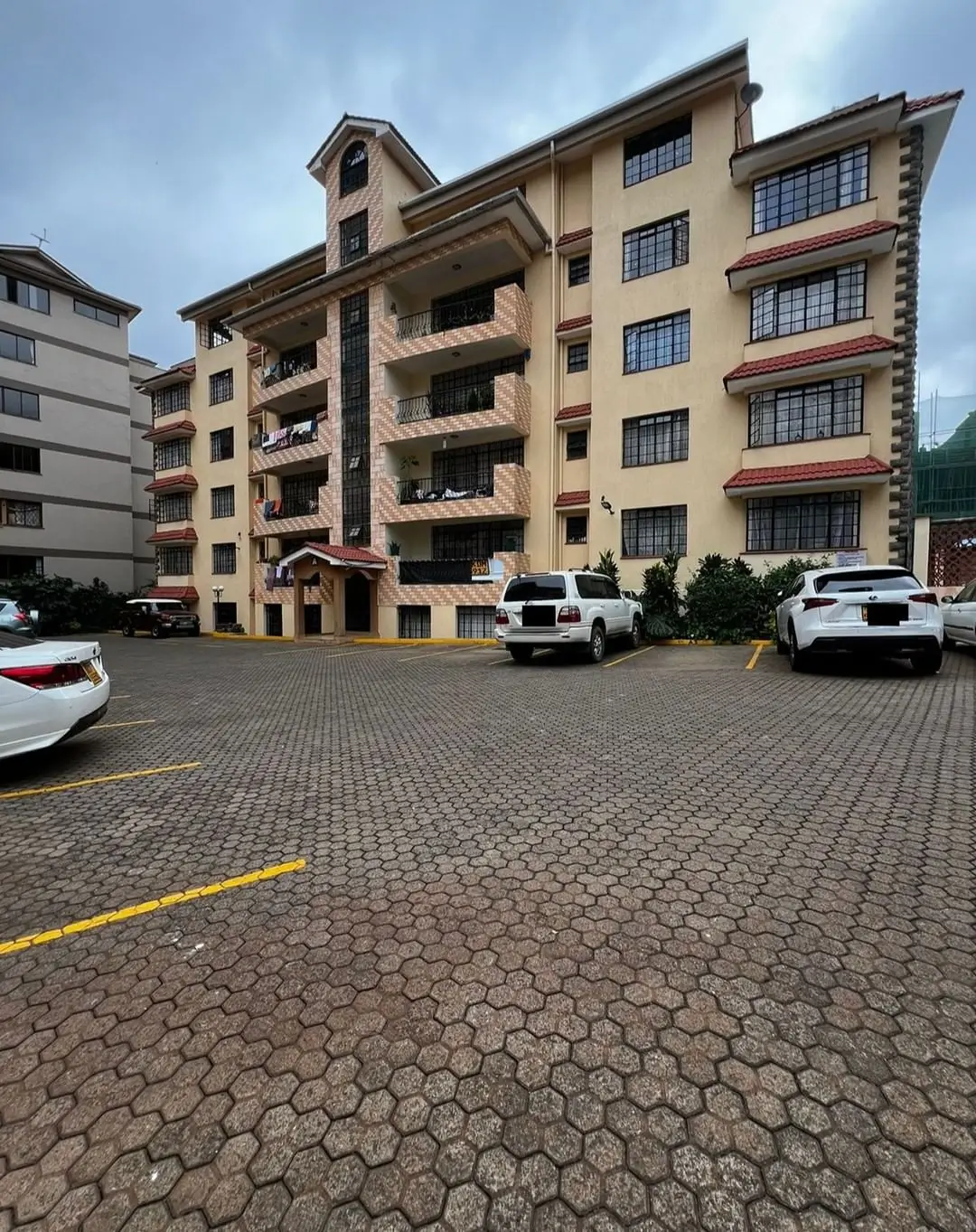 Multi-story residential building with paved parking compound