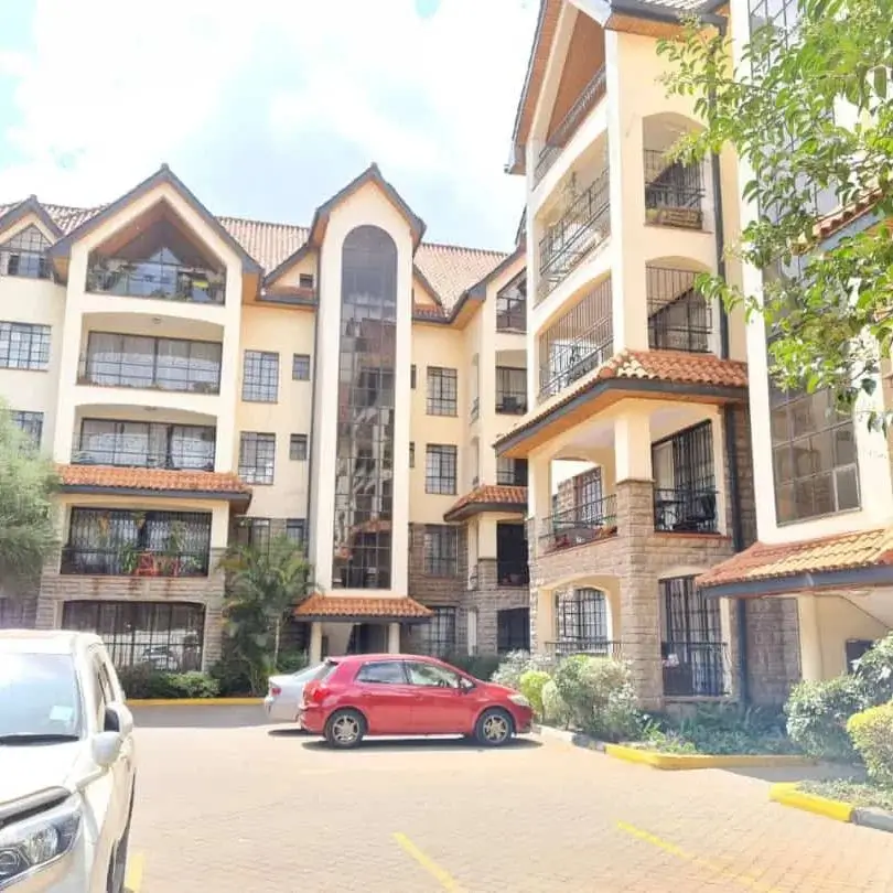 Multi-story residential building with compound parking and landscaping