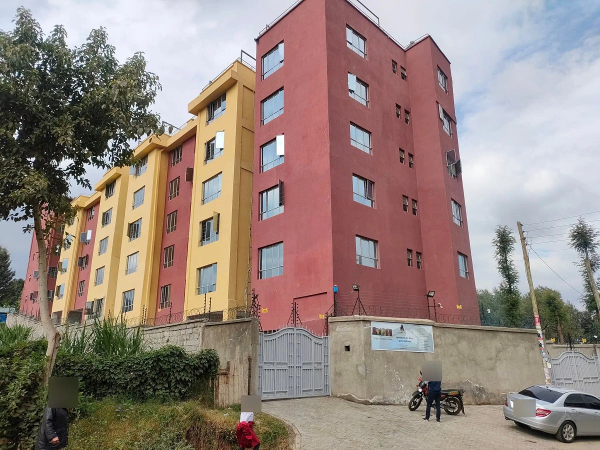 Multi-story residential building with red and yellow facade
