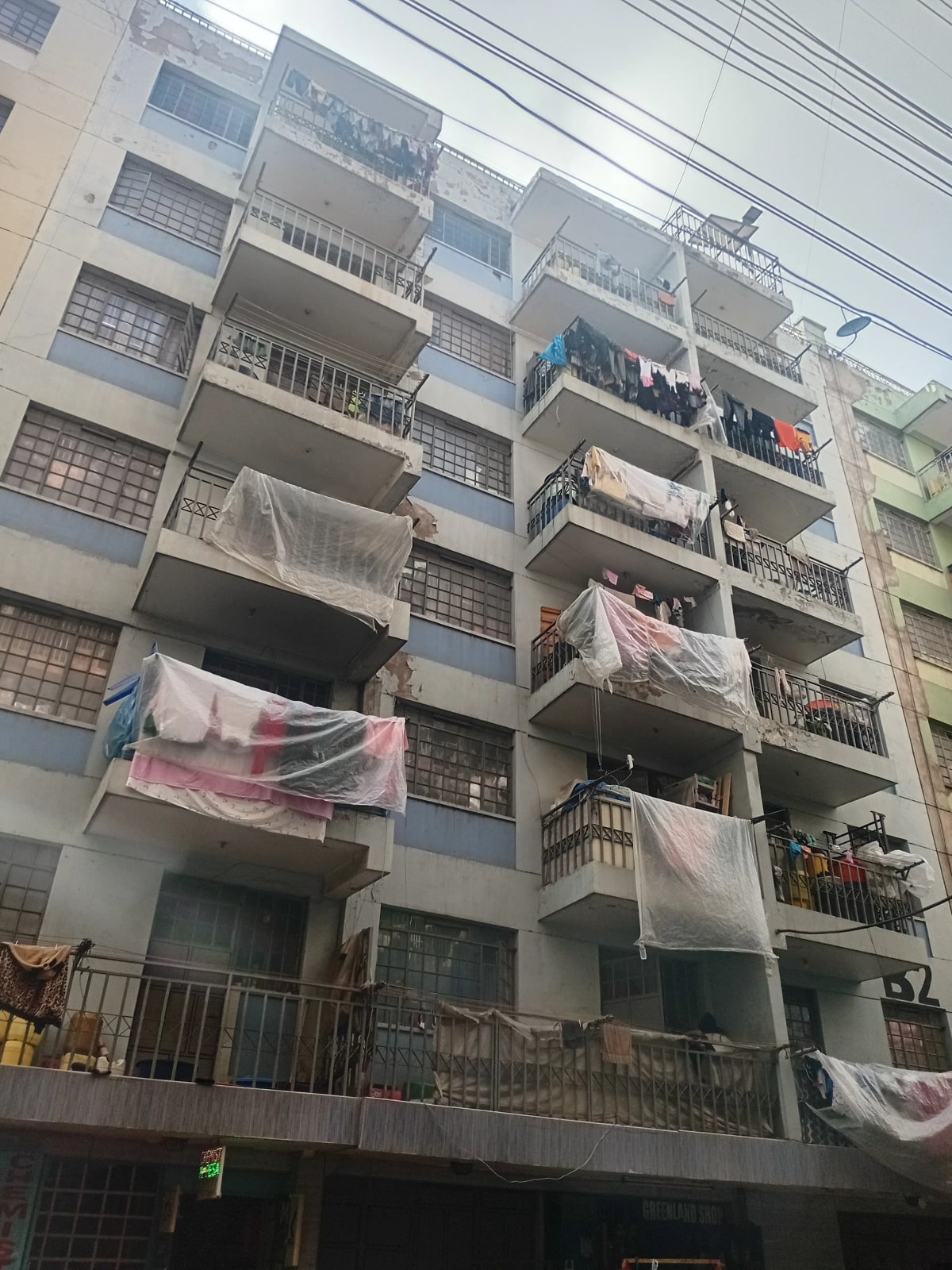 Multi-story residential building facade with balconies and laundry