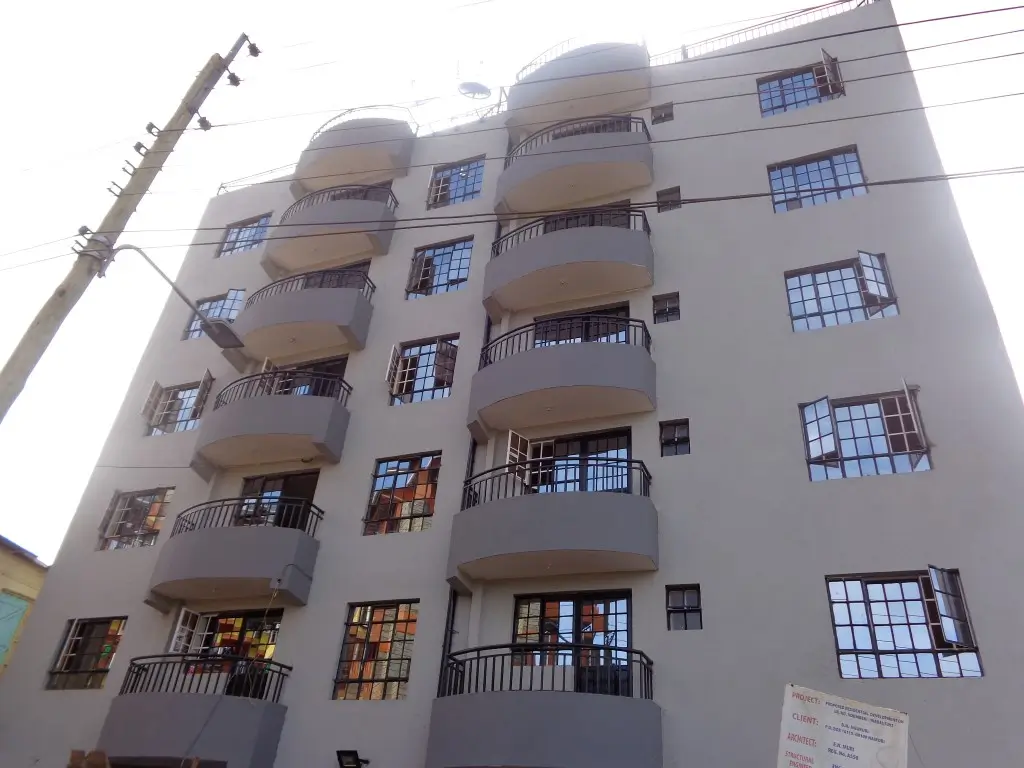 Multi-story residential building facade with balconies and windows