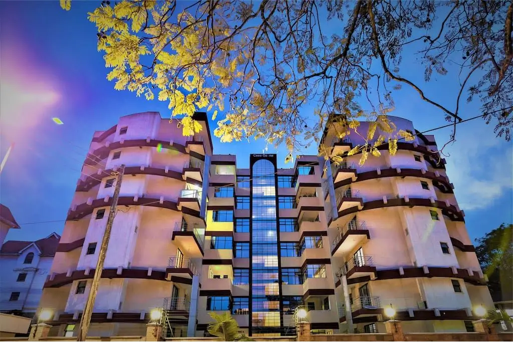 Modern residential building facade at dusk with architectural lighting