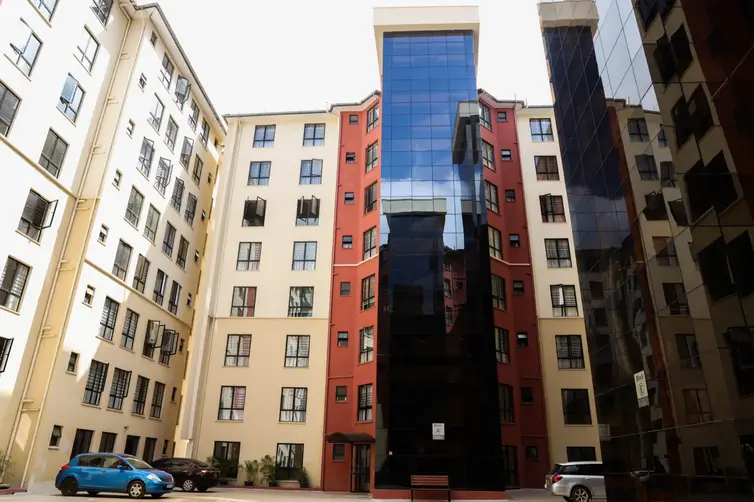 Modern mixed-use building complex with colorful facade and courtyard