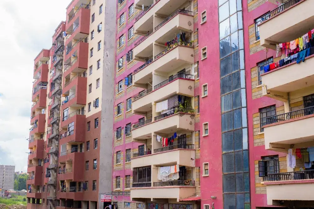 Multi-story residential building with pink and red facade