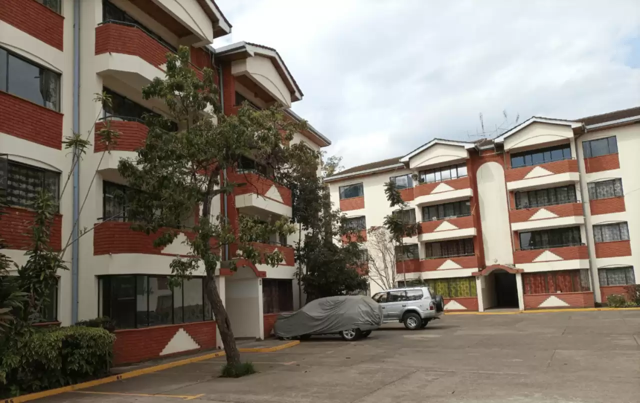 Multi-story apartment complex with red and cream facade
