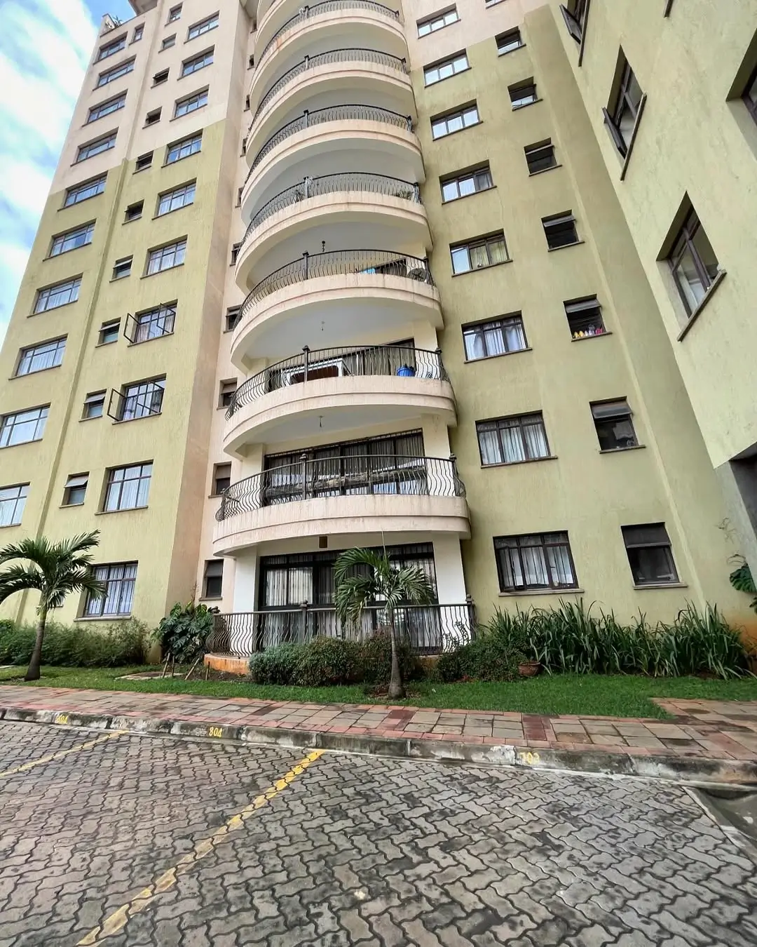 Multi-story residential building facade with curved balconies