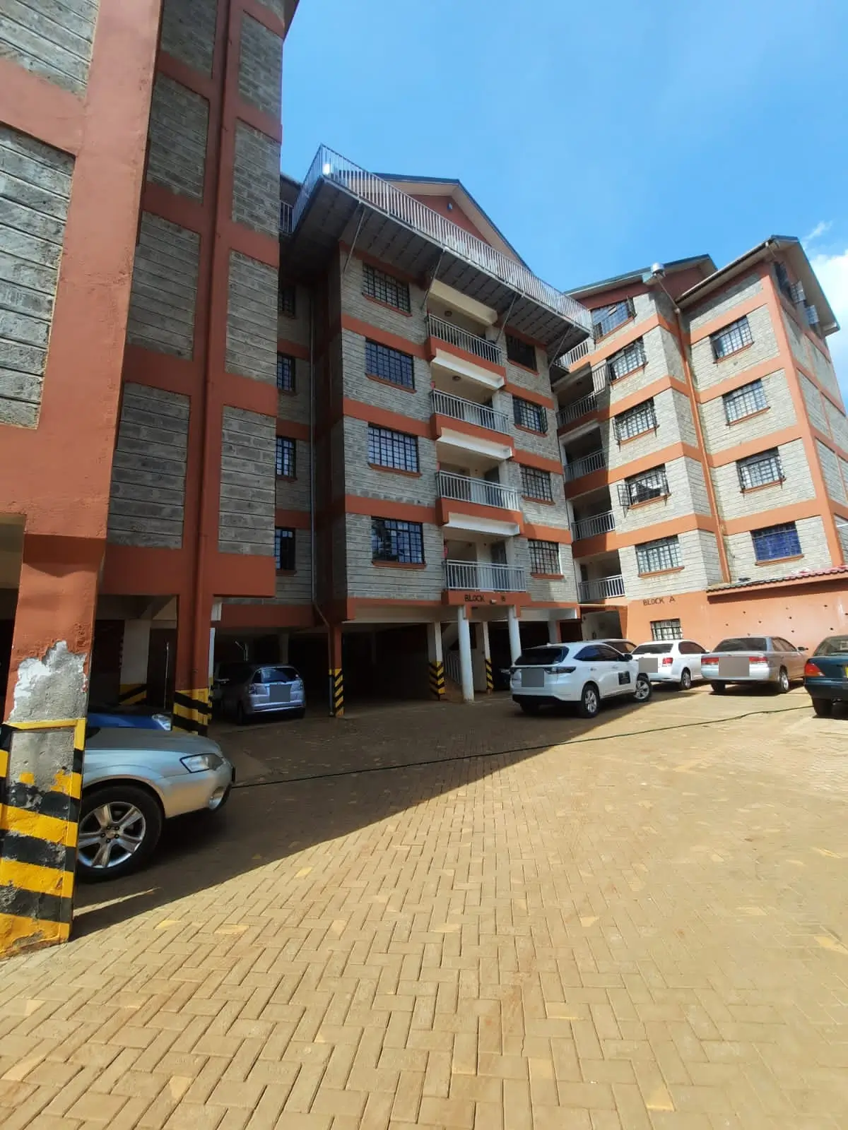 Multi-storey apartment building with spacious parking compound