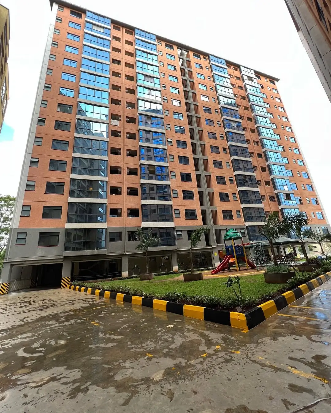 Modern multi-story residential building with brick facade and balconies