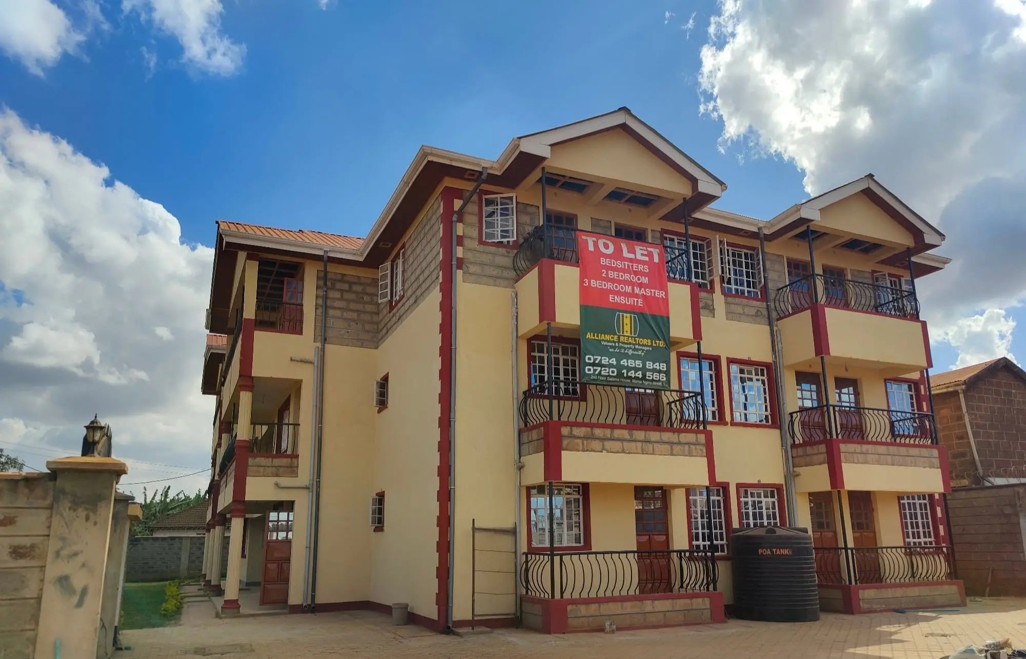 Multi-story residential building with yellow and red facade