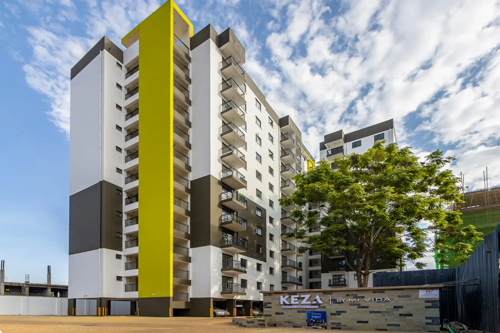 Modern multi-story residential building with yellow accent stripe
