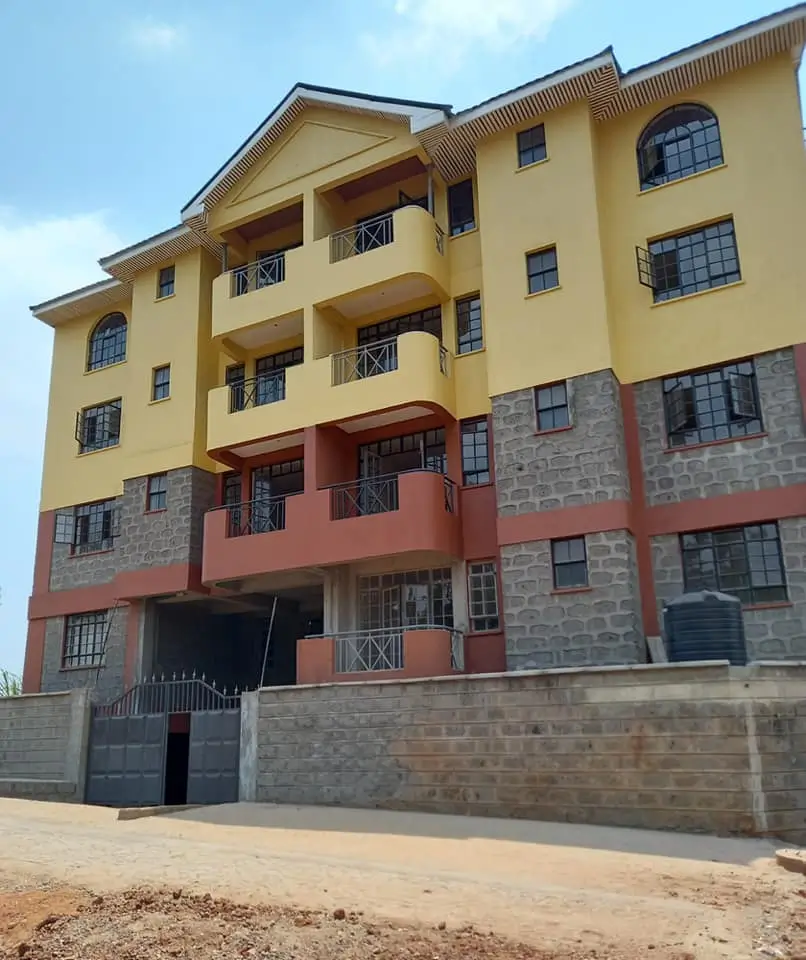 Multi-story residential building with yellow and red facade