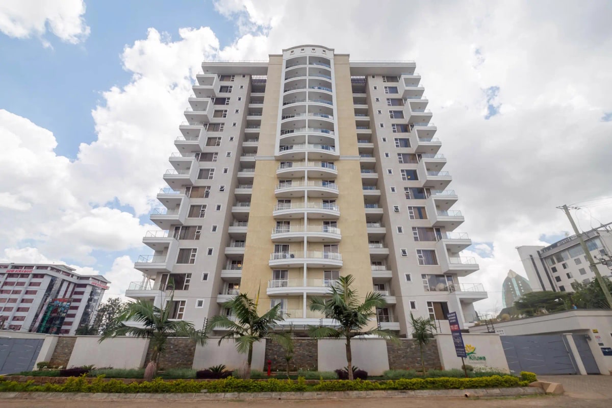 Modern multi-story residential building with landscaped compound