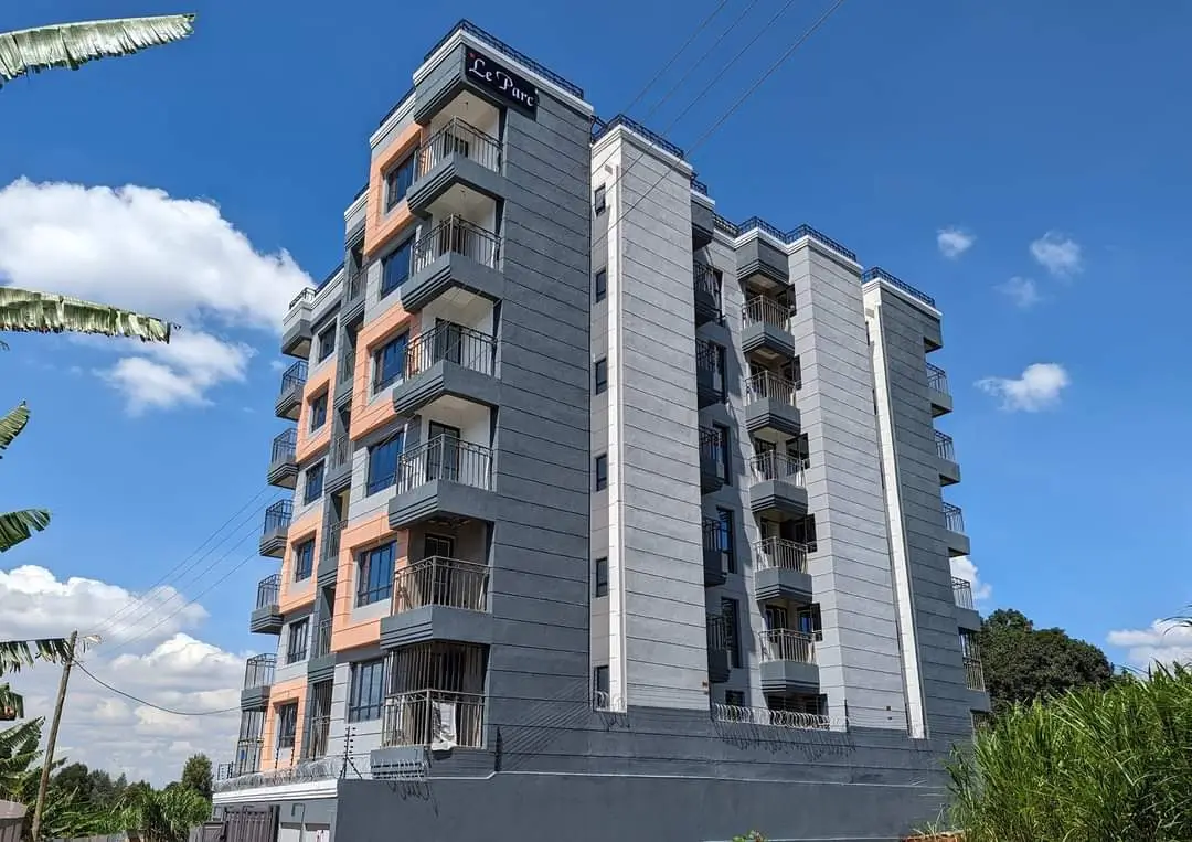 Modern multi-story residential building with balconies and clean facade