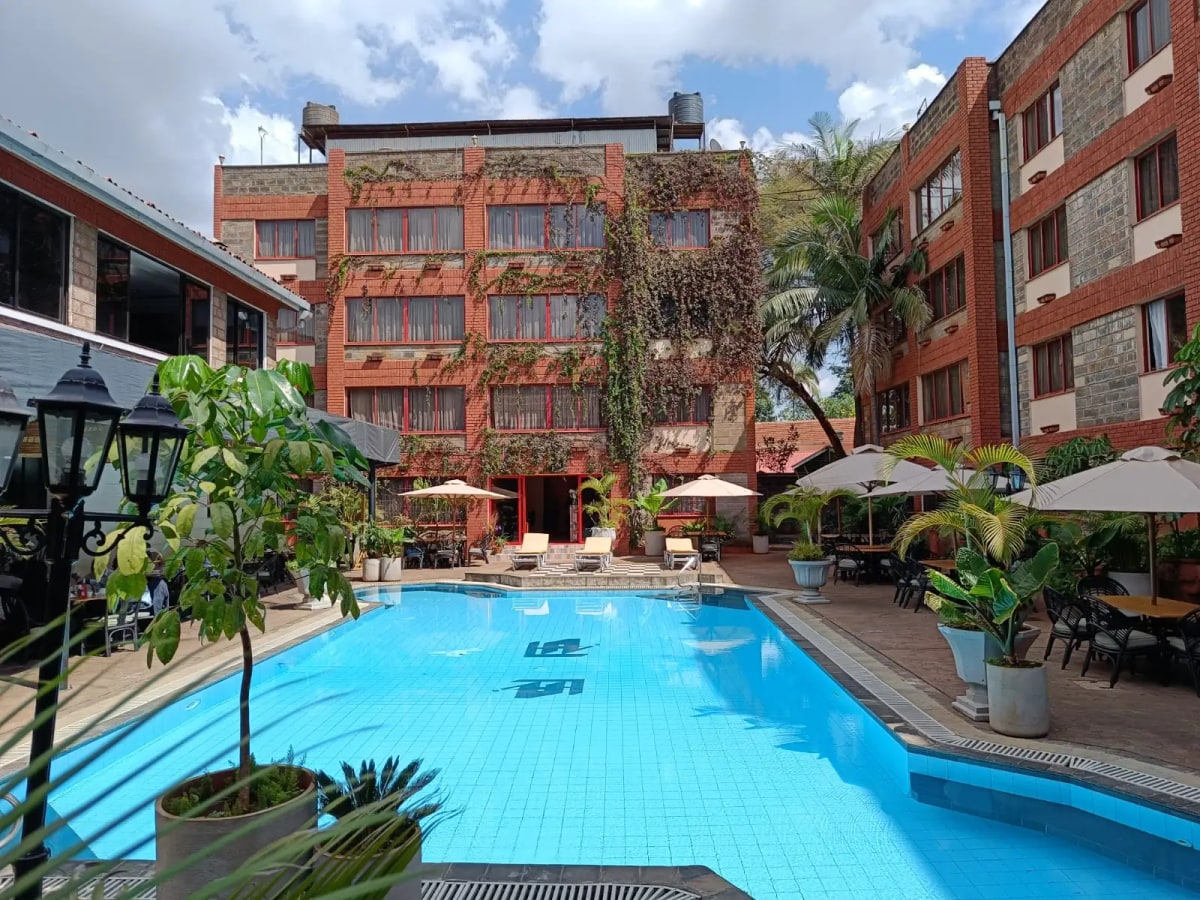 Resort-style swimming pool with loungers and tropical landscaping