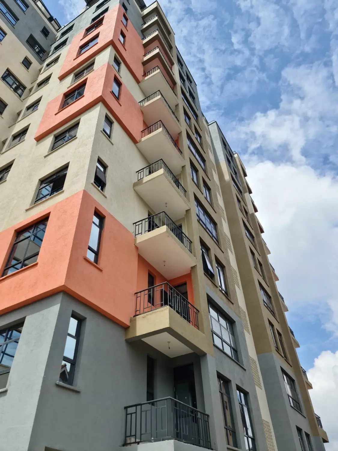 Multi-story residential building with colorful facade and balconies