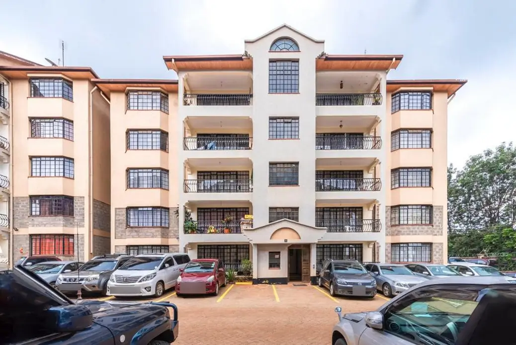 Multi-story residential building with ground-level parking compound