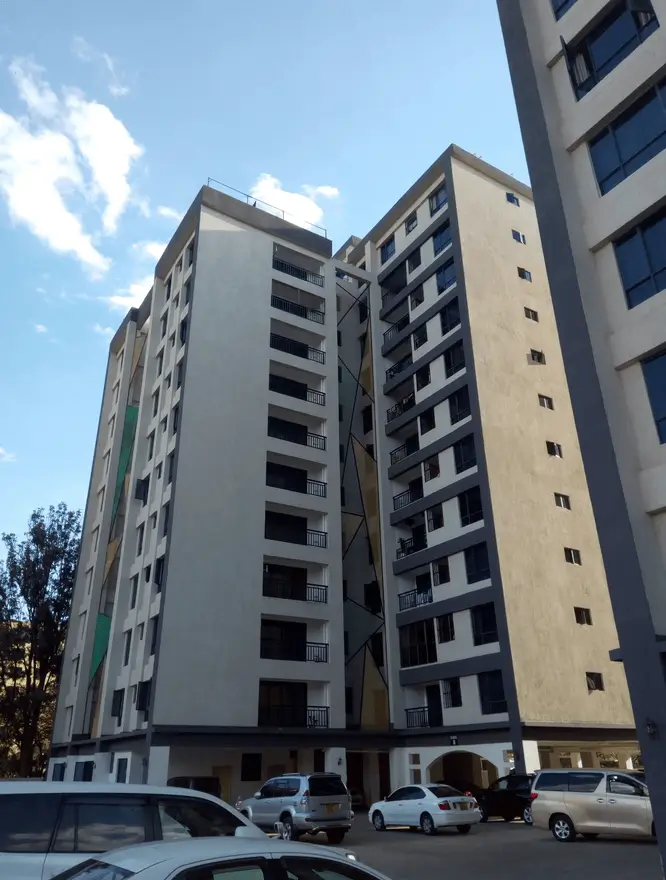 Multi-story residential building facade with ground-level parking