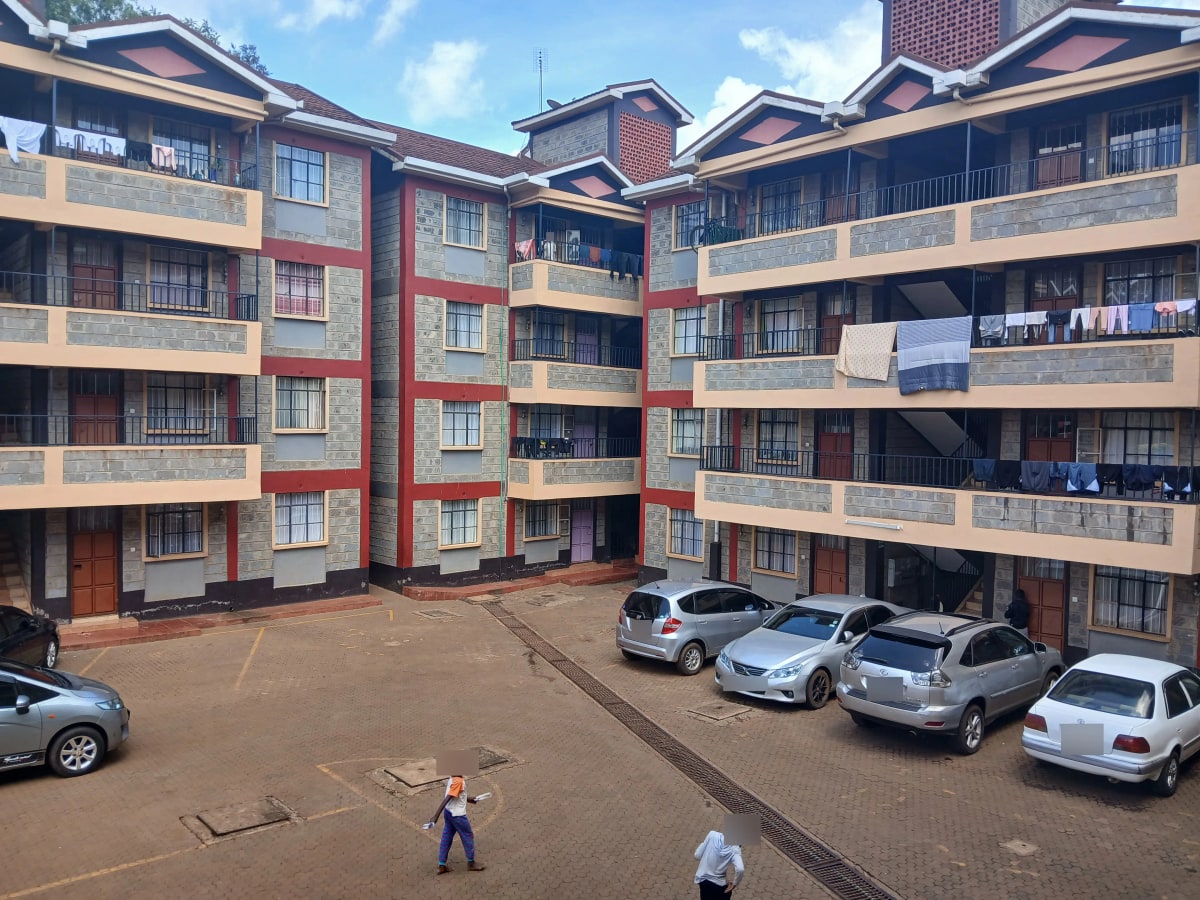 Multi-story residential compound with central parking courtyard