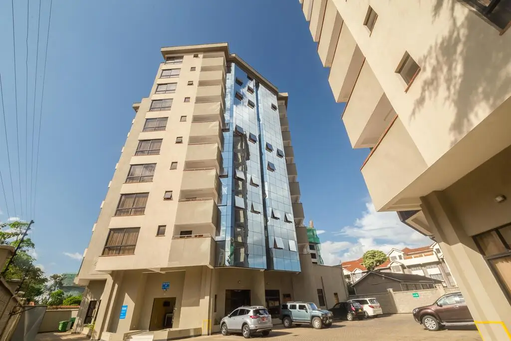 Modern mid-rise residential building with ground-level parking area