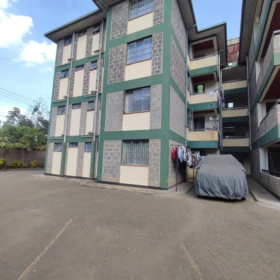 Multi-story residential building with green and cream facade