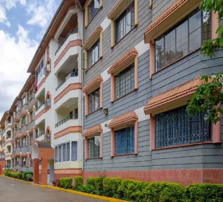 Modern multi-story residential building with terracotta trim and balconies