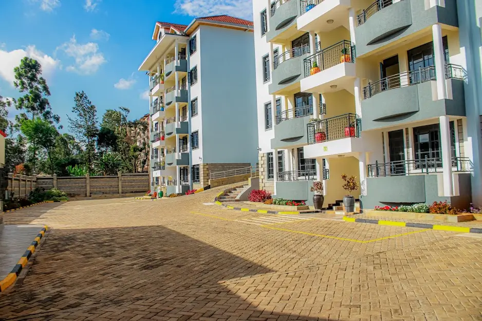 Multi-story residential compound with paved courtyard and landscaping