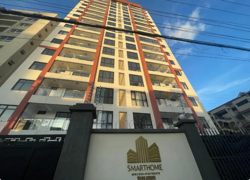 Multi-story residential building facade with red and cream trim