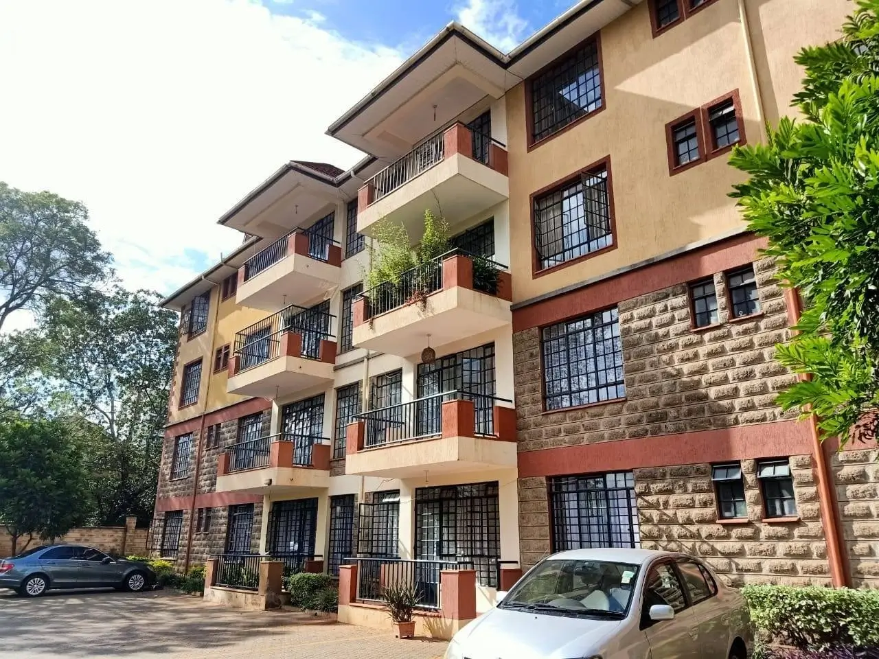 Multi-story residential building with cream and red facade