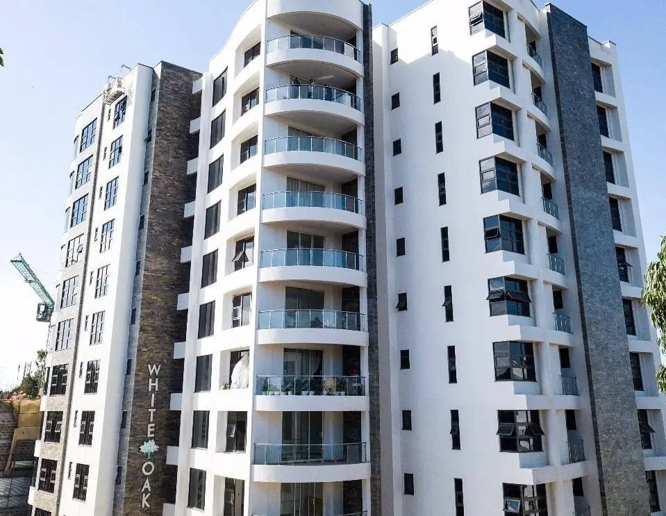 Modern multi-story residential building with curved balconies