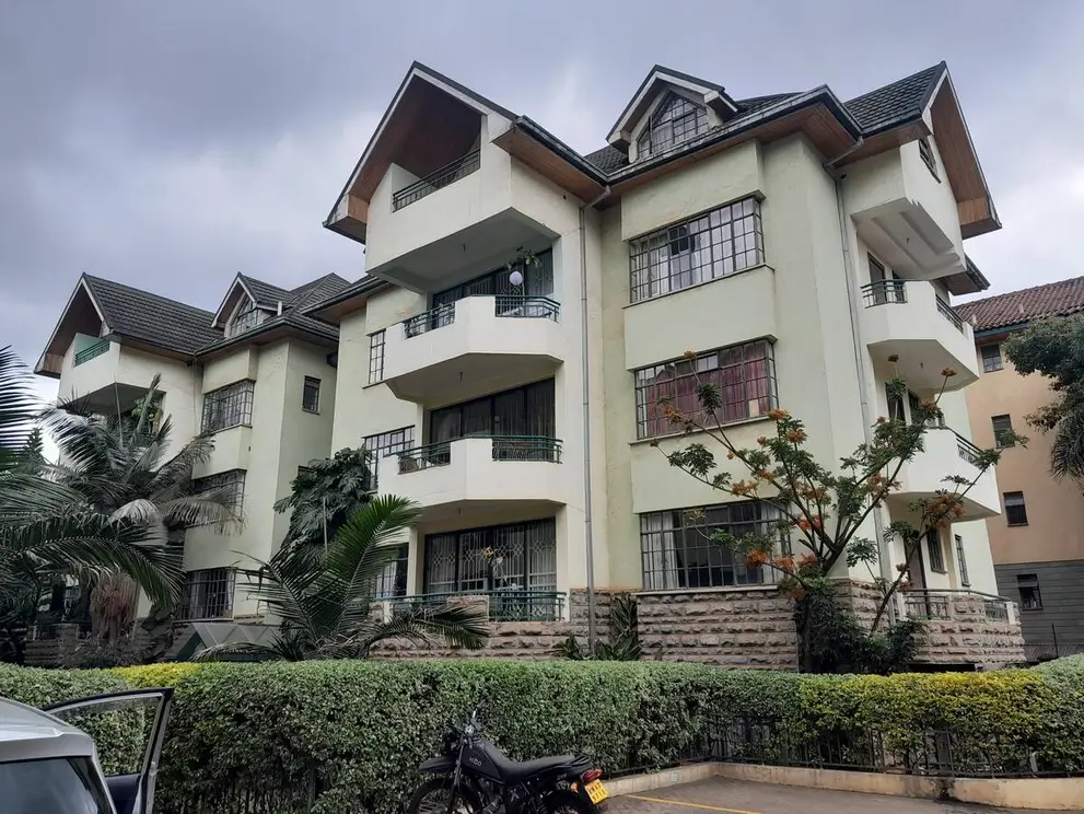 Multi-story residential building with cream facade and balconies