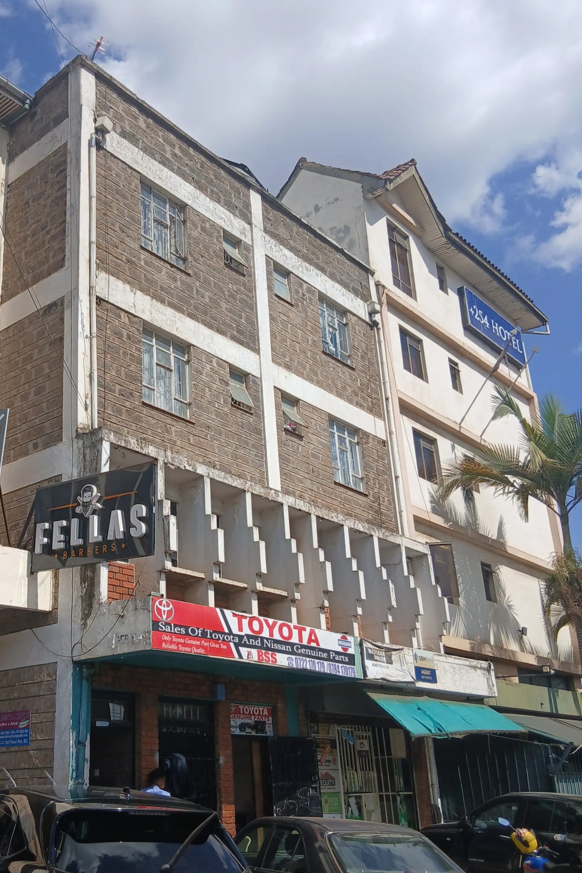 Multi-story residential building facade with ground-floor shops