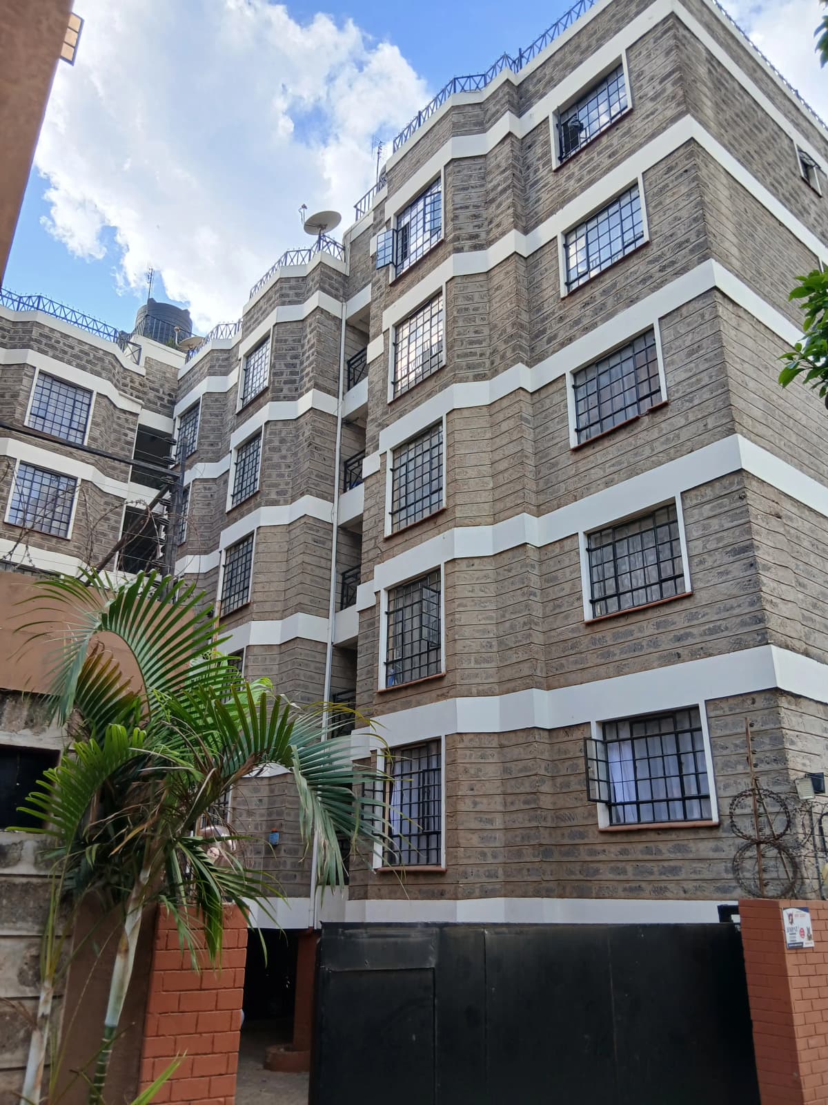 Multi-story residential building facade with stone cladding