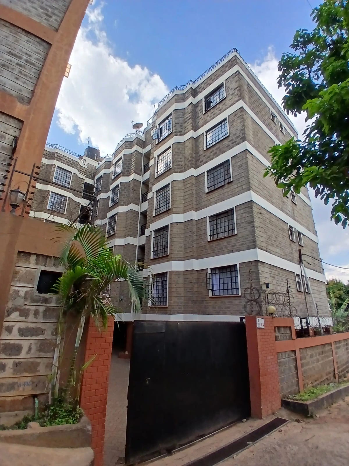 Multi-story residential building with brick and stone facade