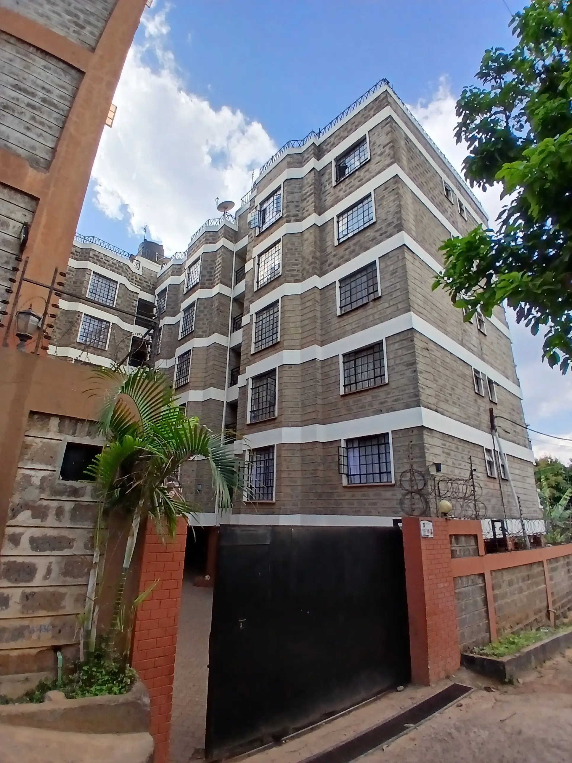 Multi-story residential building with brick and stone facade