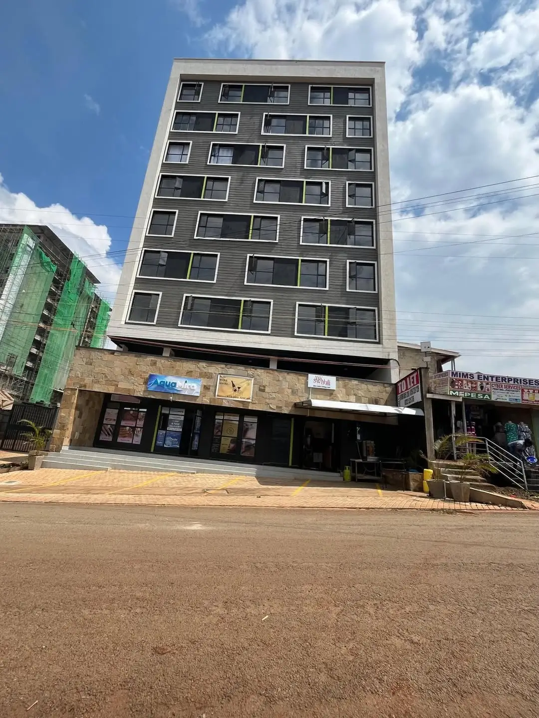 Modern multi-story residential building facade with ground floor retail