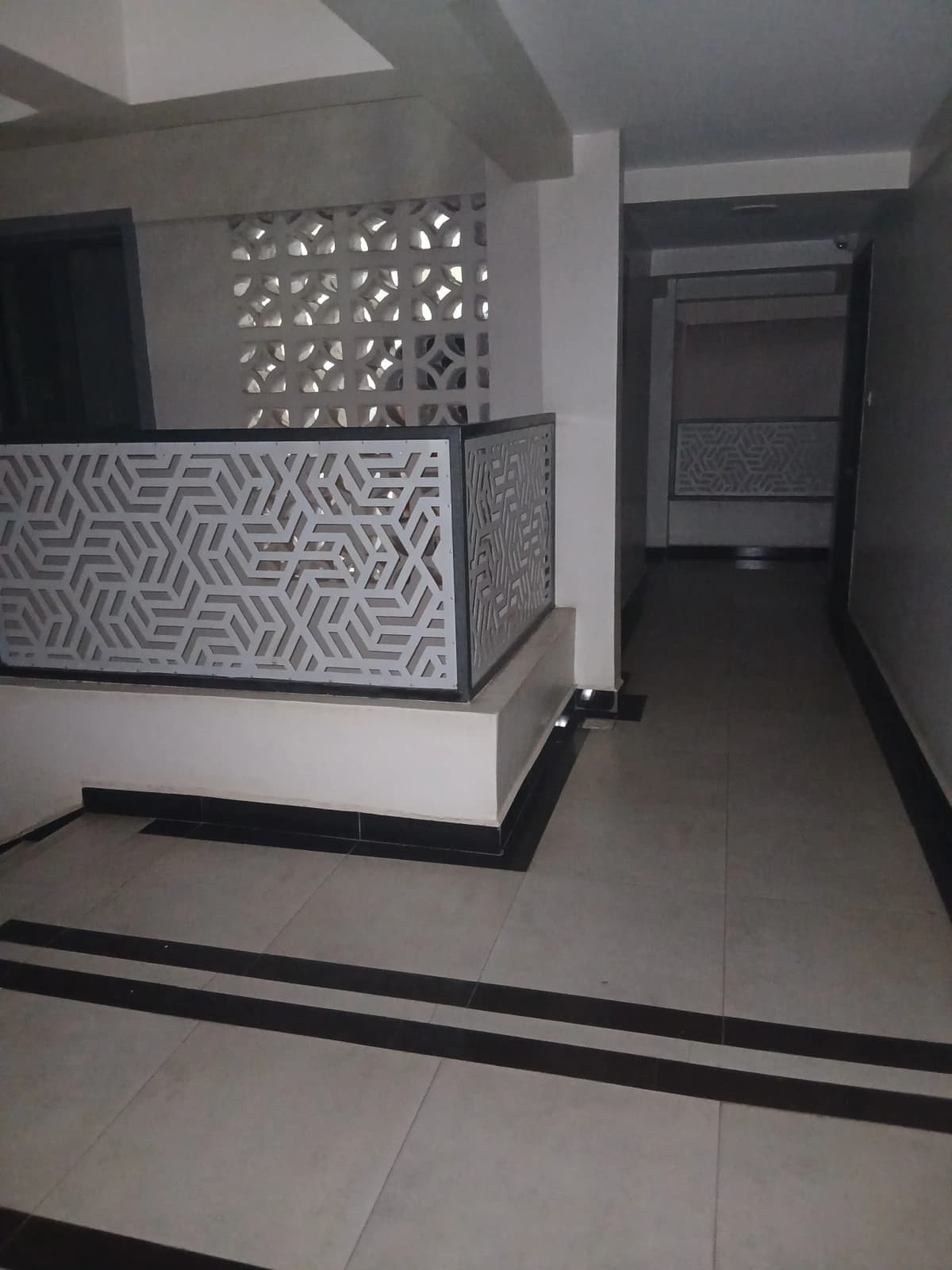 Modern building lobby with decorative partition wall and corridor