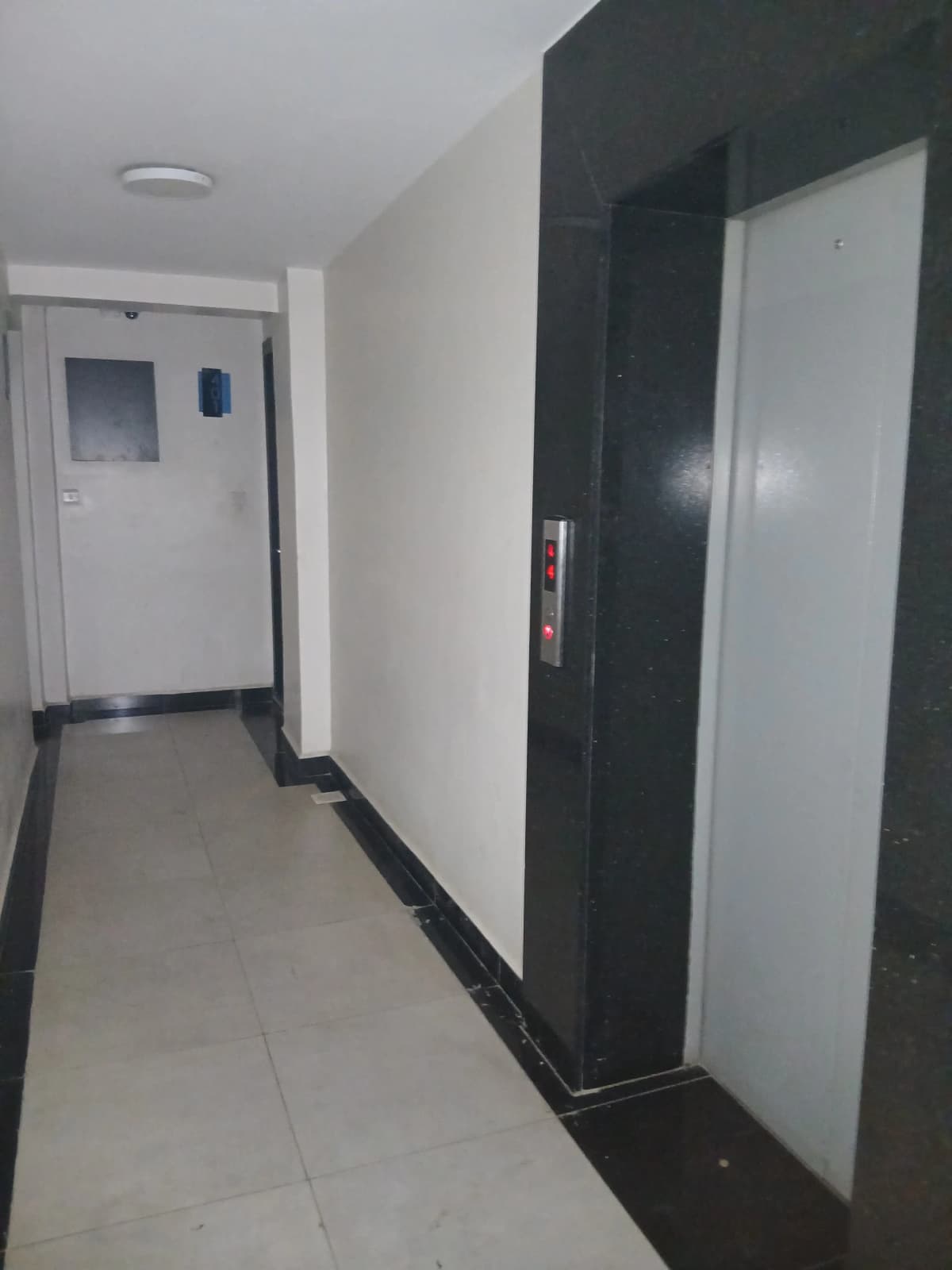 Building corridor with elevator and entrance door
