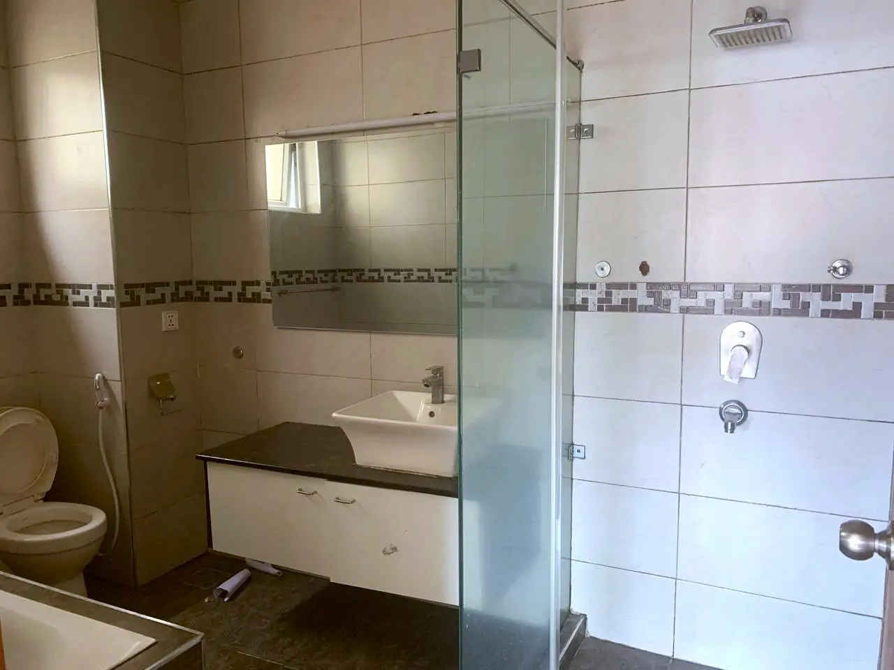 Modern bathroom with glass shower enclosure and vanity sink