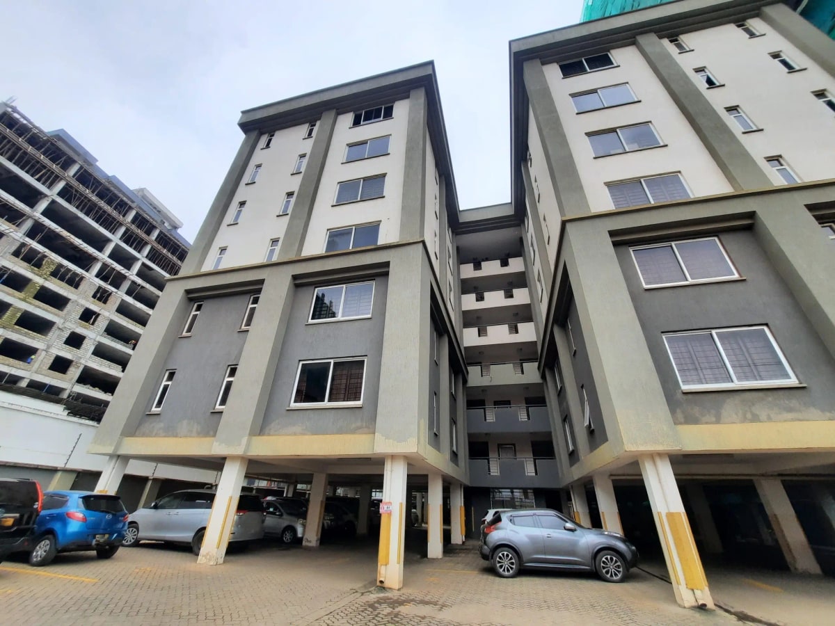 Modern apartment complex with ground-level parking bays
